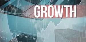 Digital chart with upward trend lines overlaid on skyscrapers, with the word 